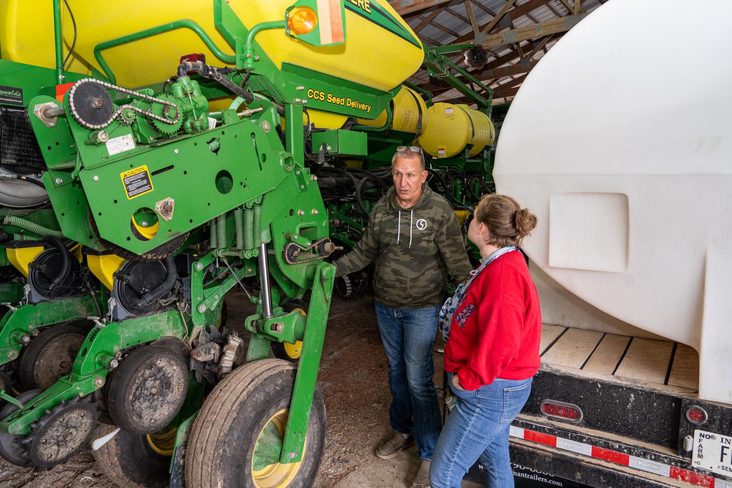 Greg Woll explains the functions of his soybean planter to Indiana NRCS intern Carly Whitmore during a visit to his farm in Columbia City, IN July 16, 2021