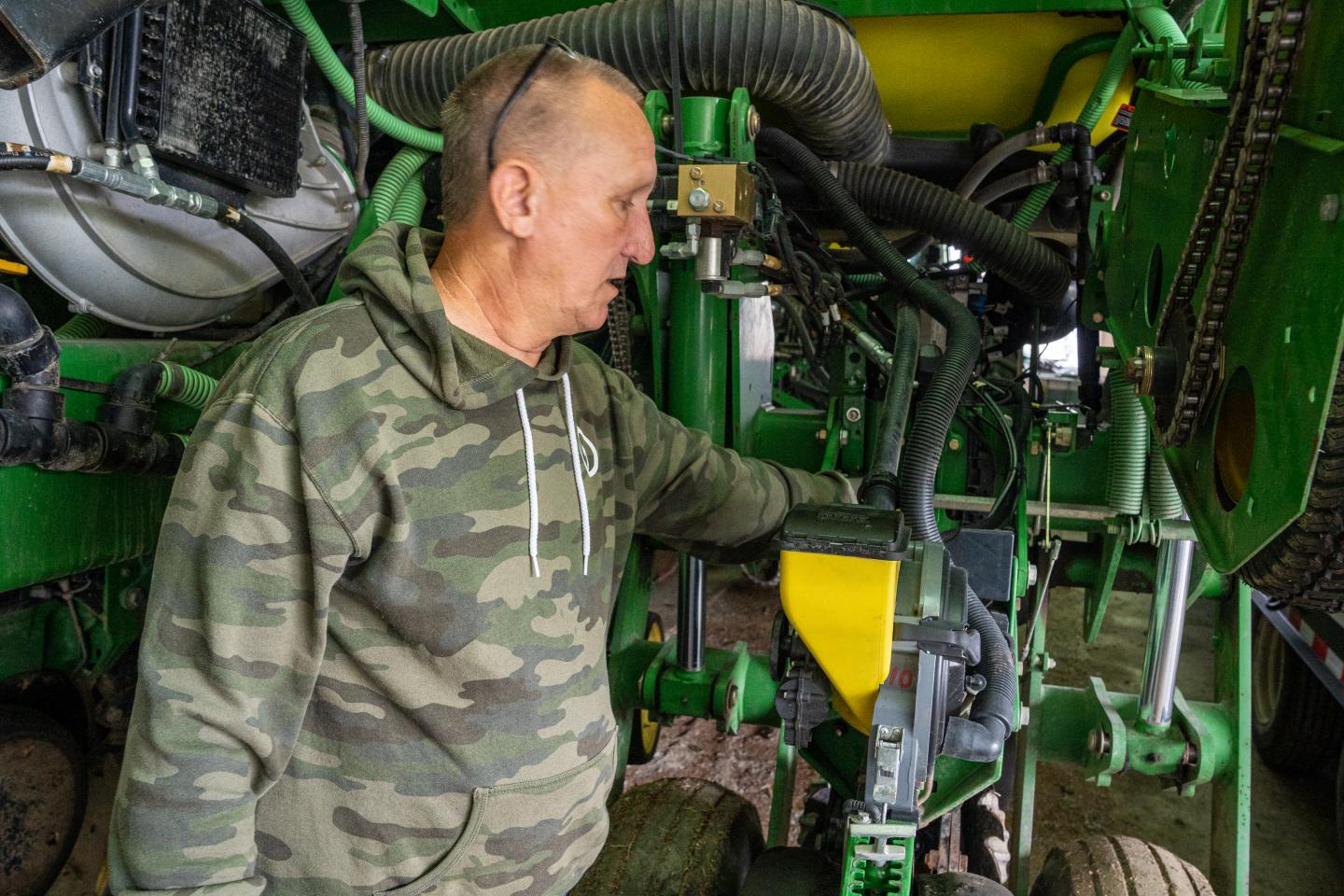 Greg Woll explains the functions of his soybean planter during a visit to his farm in Columbia City, IN July 16, 2021.