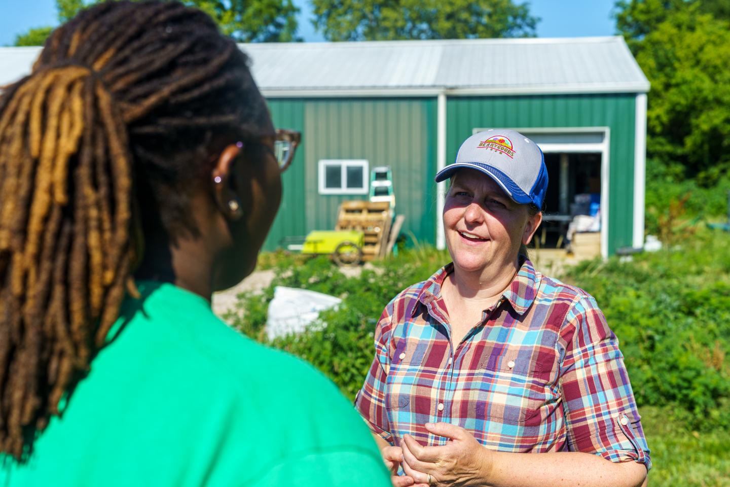 Sydnee Lockett (left) talks to Amy Surburg about her farming operation at Berry Goods Farm in Indiana.