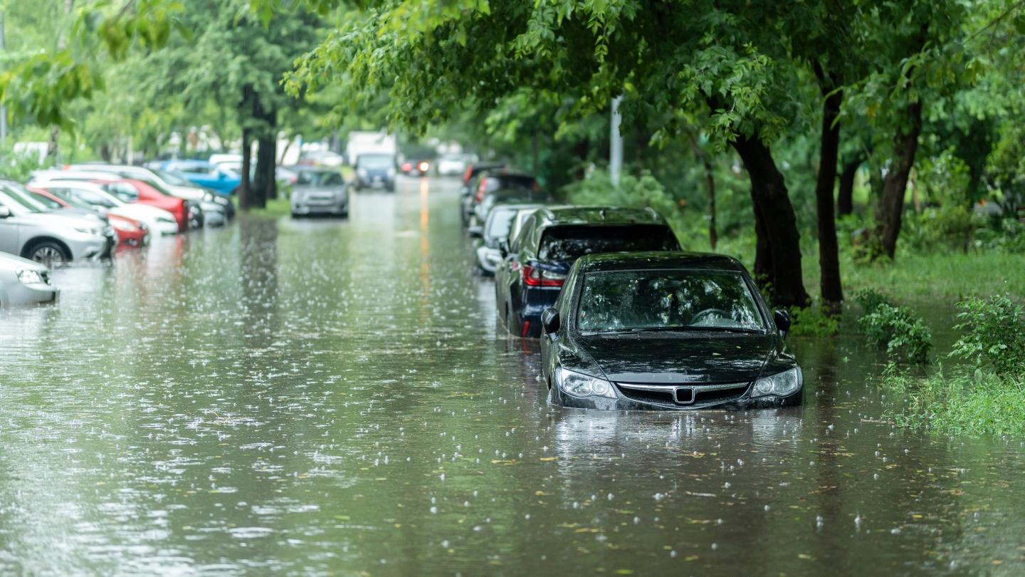 Flooded street with parked cars