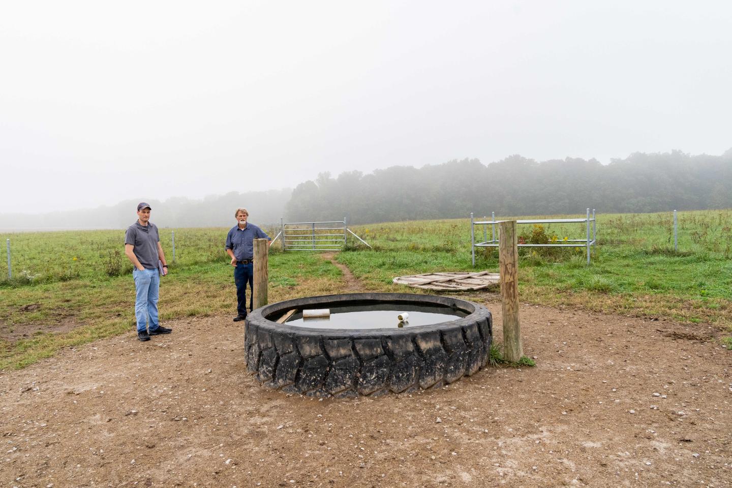 Indiana NRCS district conservationist Thomas Perkins (left) and Jerry Bates inspect a watering facility at Bates' beef cattle operation in Cloverdale, IN.