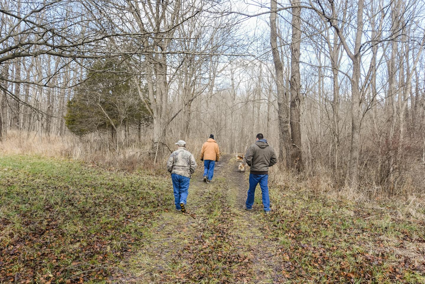 Peggy and Allen Royer, who own Wagoner Christmas Tree Farm in Putnam County, Indiana, walk through the timberland that surrounds the farm with Indiana NRCS District Conservationist Thomas Perkins Dec. 14, 2020.