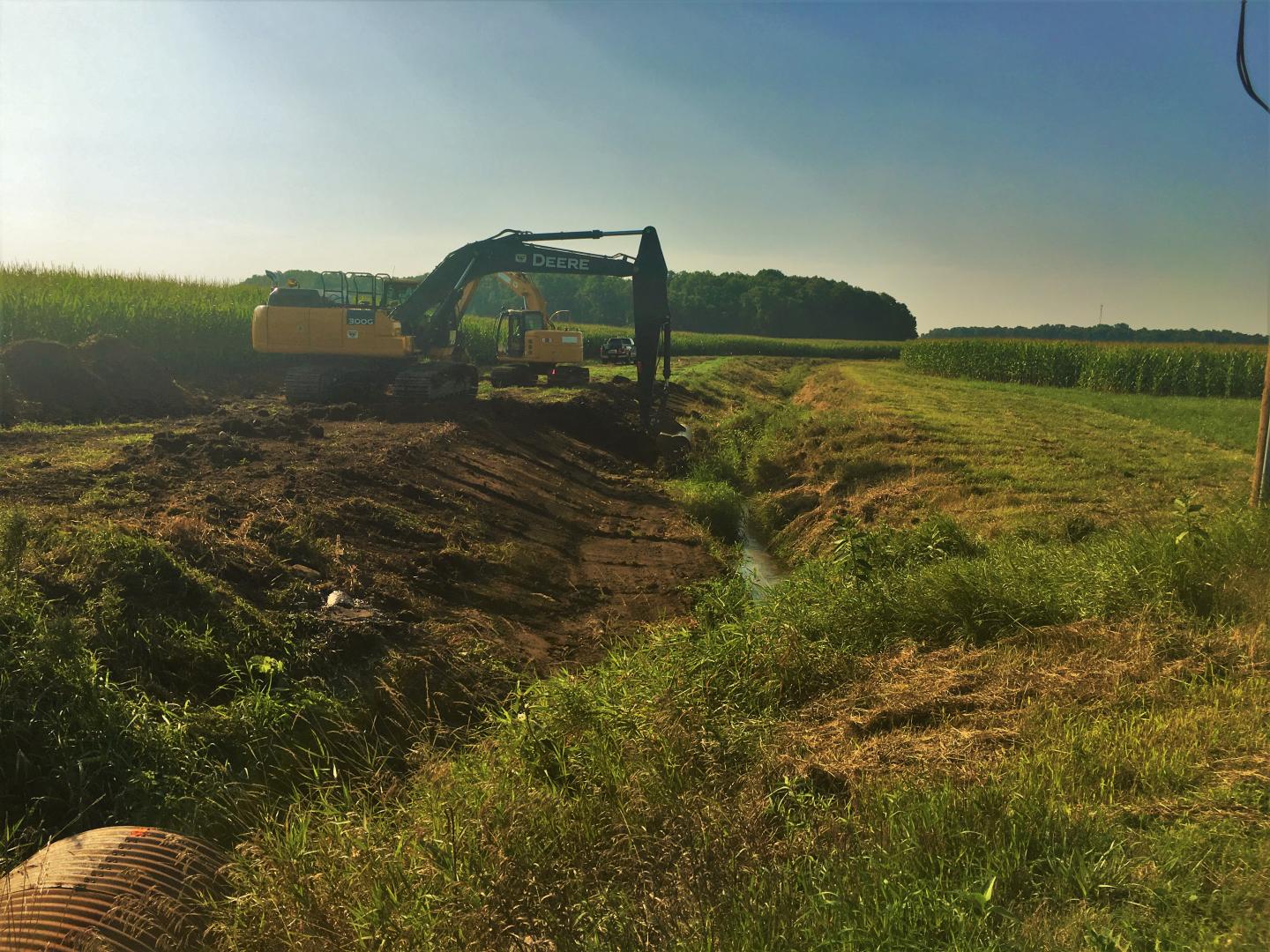 Construction begins on the two-stage ditch.  Excavators are used to dig out the ditch benches, increasing channel stability and reducing bank erosion.