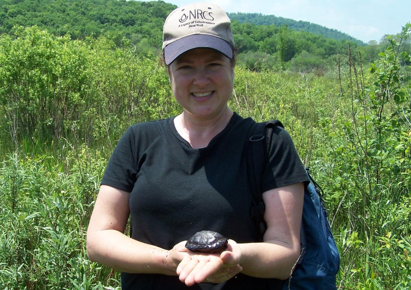 NRCS Biologist Elizabeth Marks holding bog turtle