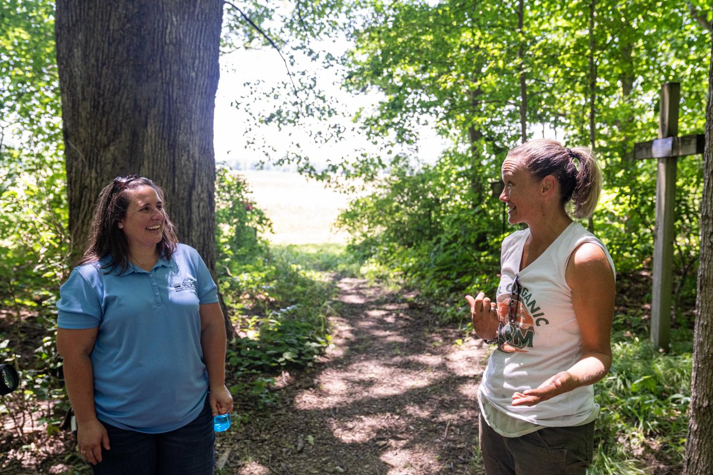 Katy Rogers (right), the farm manager at Teter Organic Farm and Retreat Center in Noblesville, Indiana, gives a tour of the farm to NRCS district conservationist Angela Garrison June 21, 2022. 