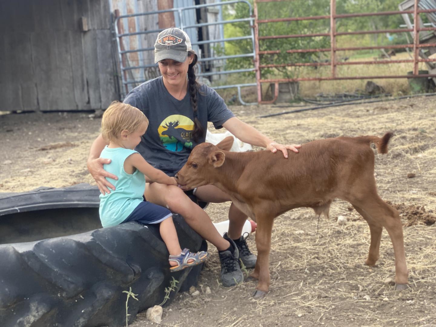 Mandy Krause with one of her three sons play with a calf on the Parker Creek Ranch in D’Hanis, Texas. The ranch has been in operation for 13 years. In addition to pasture-raised poultry, Parker Creek Ranch also raises beef cattle, using regenerative production techniques.