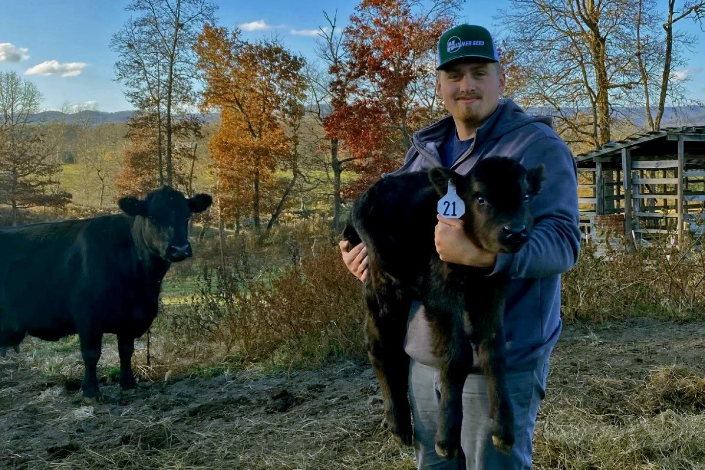 Virginia Earth Team Volunteer, Chase Musser gets a close-up view of some Southwest Virginia livestock. 