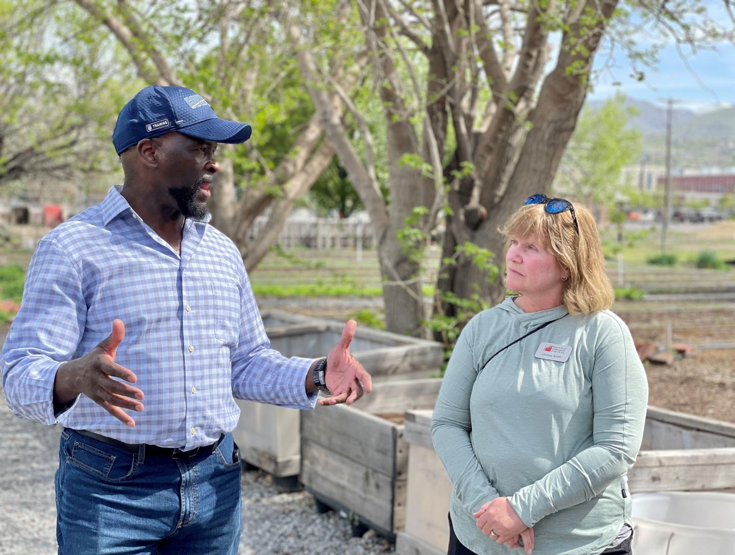 Astor Boozer, NRCS Regional Conservationist for the West Region, talks with Lindsey Oswald Smith, Wasatch Community Garden Director of Foundation Giving, during a tour of the Green Phoenix Farm.