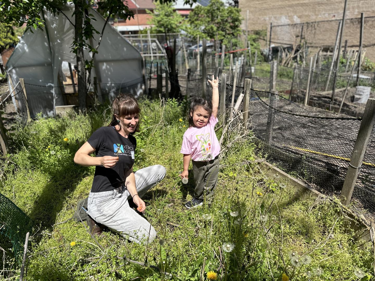 picture of woman and child in garden plot