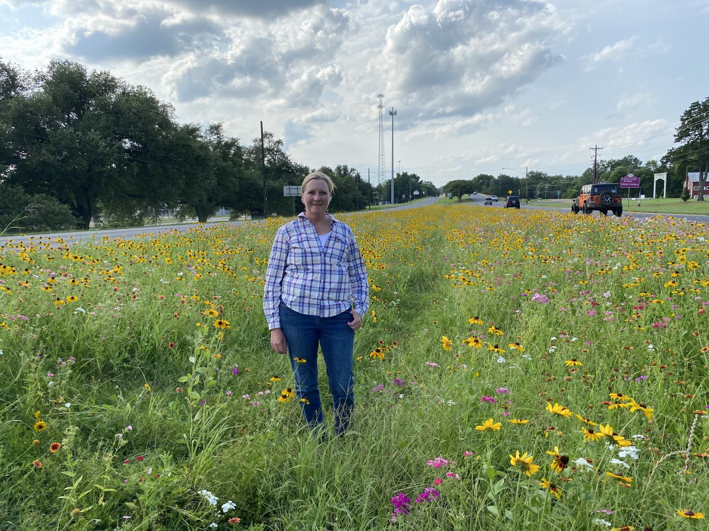 Dawn Stover, an agronomist with the East Texas Plant Materials Center stands in the middle of the native plant median she helped develop.