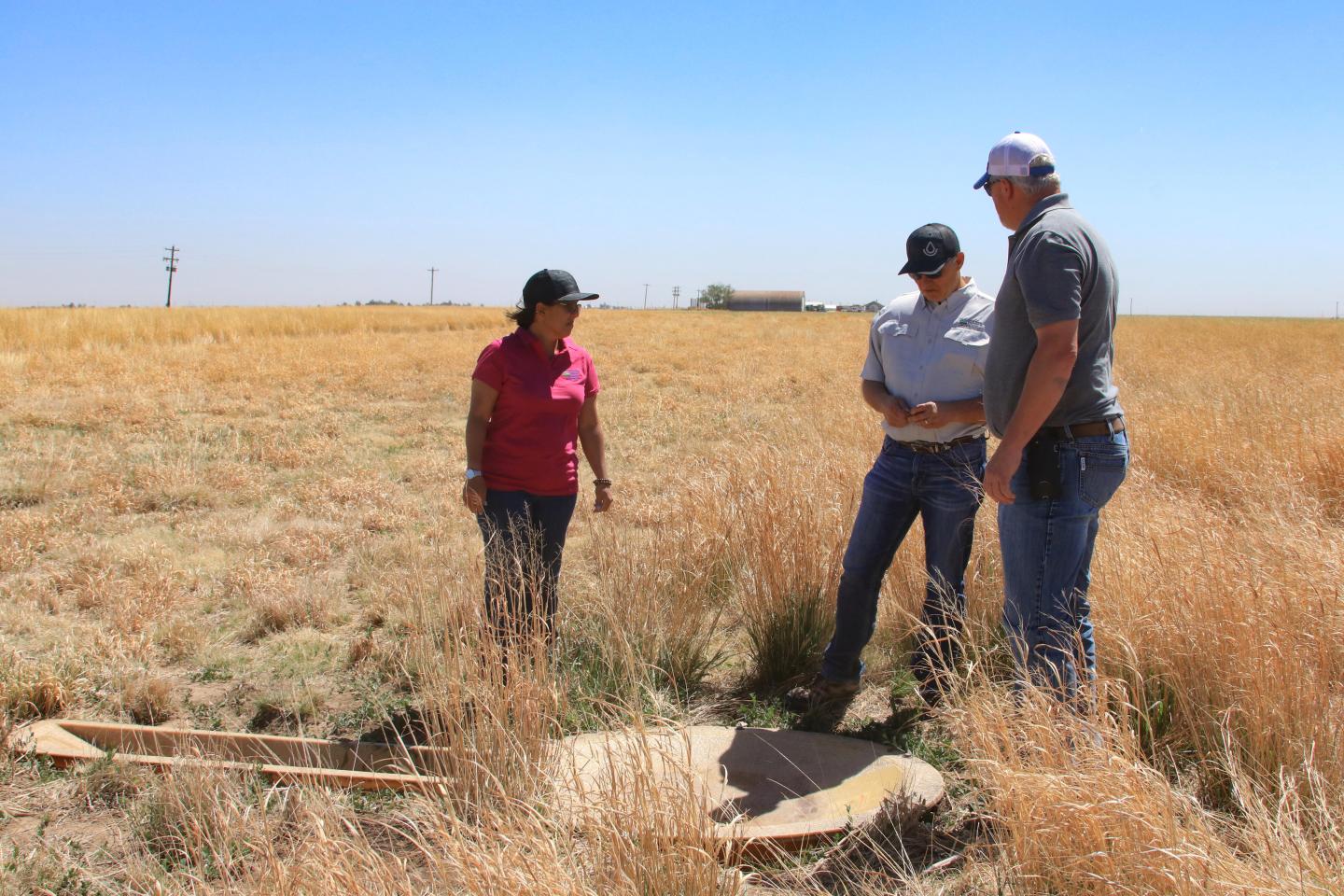 NRCS personnel in a field with farmer Bryce Williams