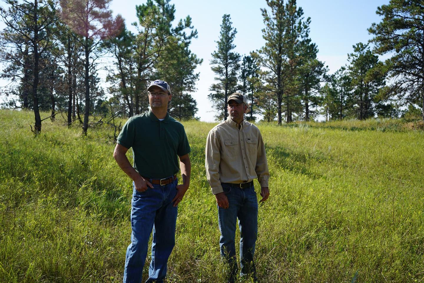 Andy Miller, Montana DNRC, and Erik Peterson, landowner, view an area treated to reduce conifer encroachment in Custer County.