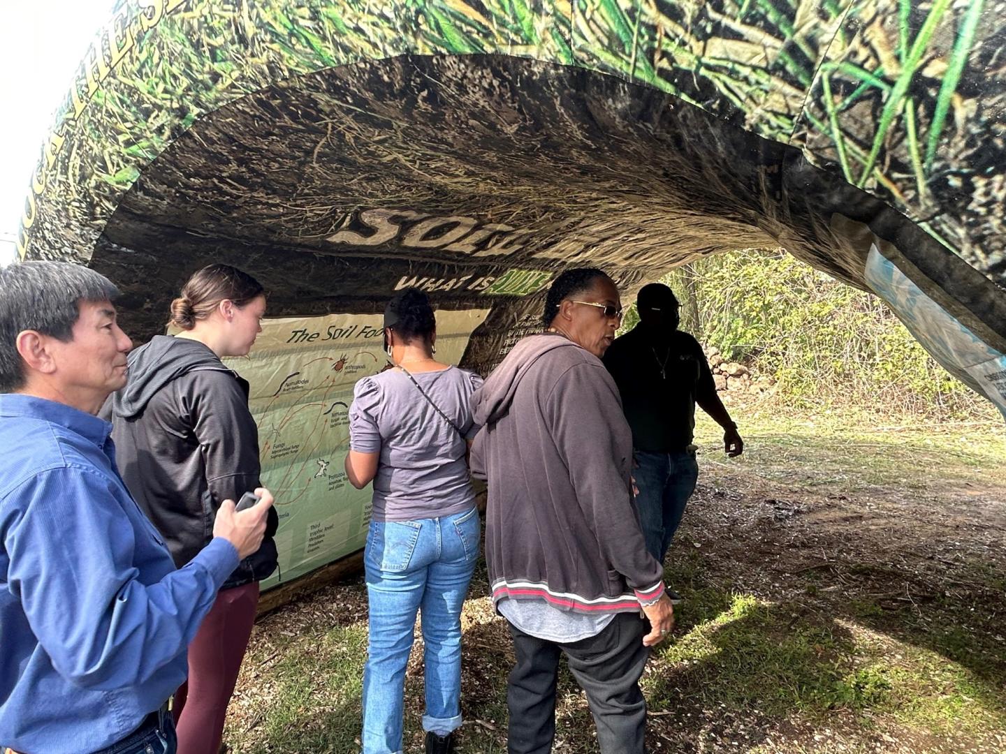 People walking through soil tunnel