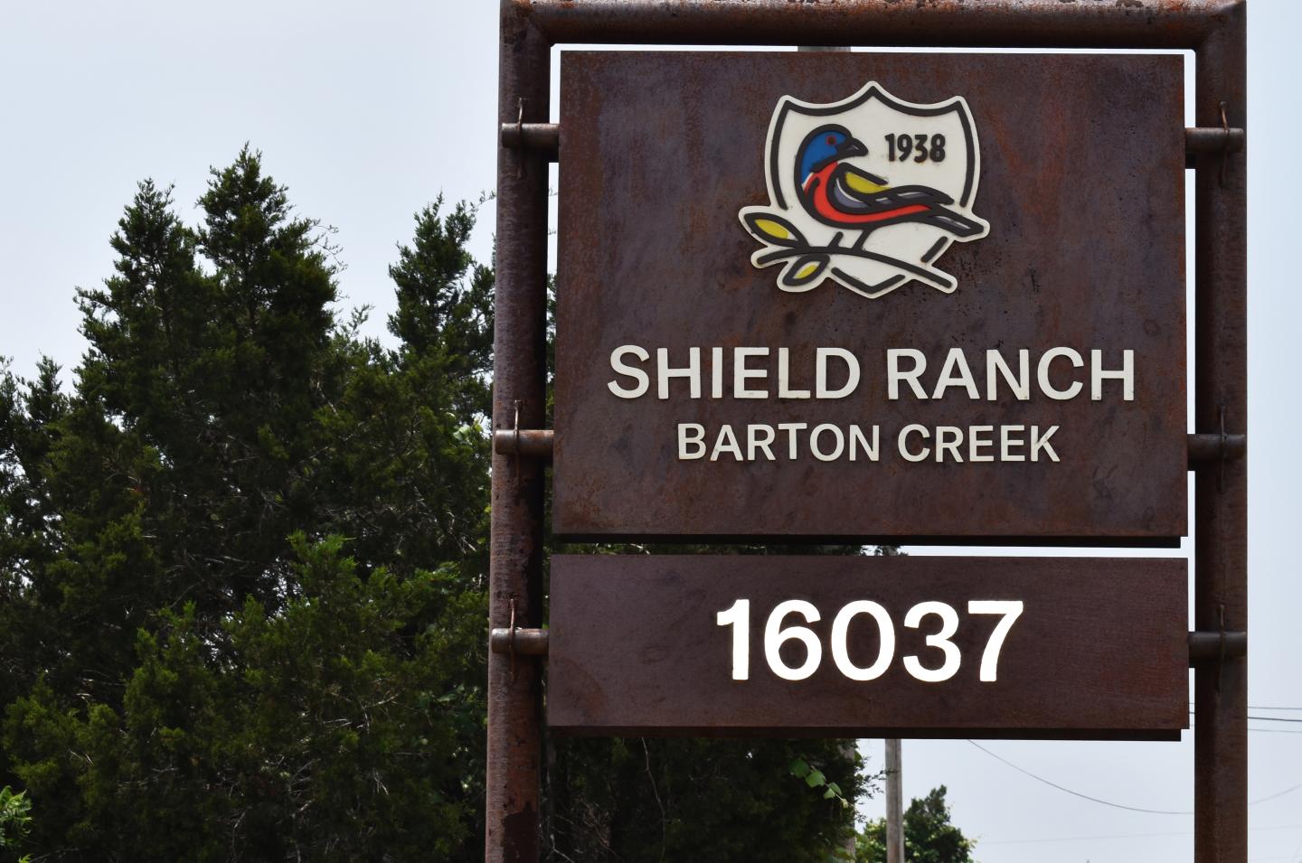 A sign placed outside of the two-mile-long gravel road of Shield Ranch Barton Creek outside of Austin, Texas, welcomes visitors.