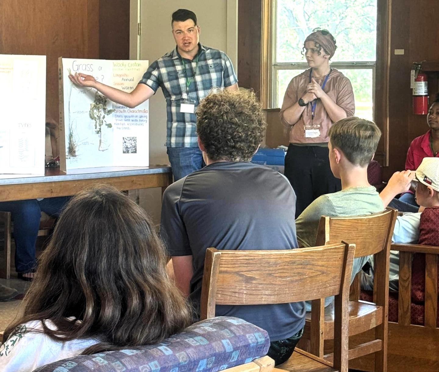 Joshua Bushell teaching at the Comal-Guadalupe Soil and Water Conservation District Range Camp to students in the audience.