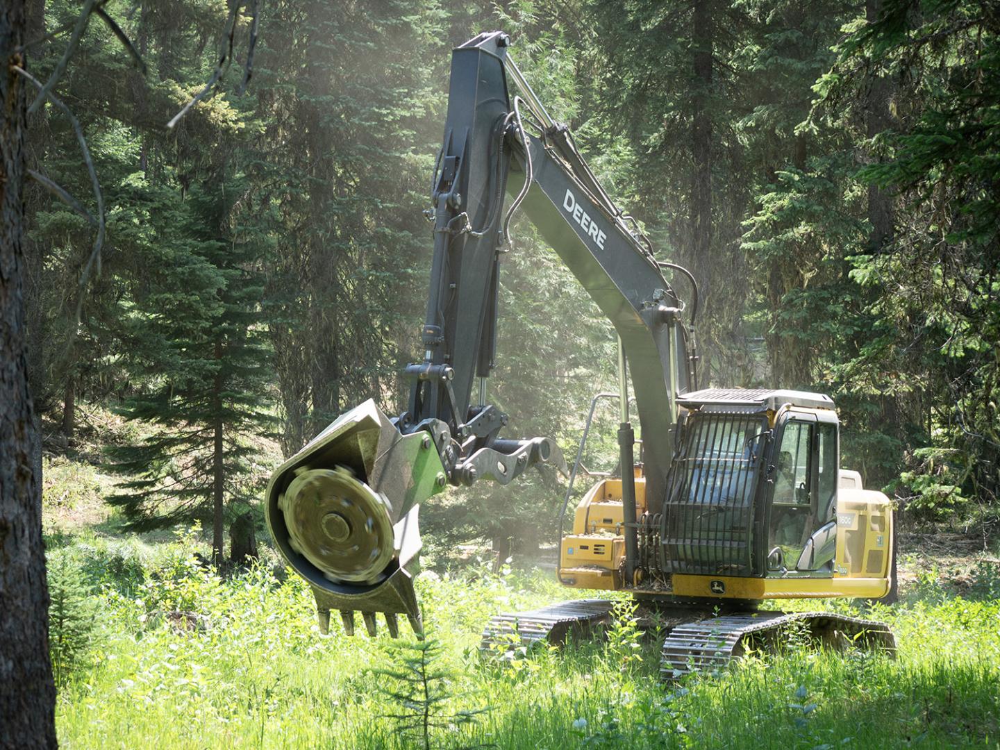 A masticator on the arm of an excavator.