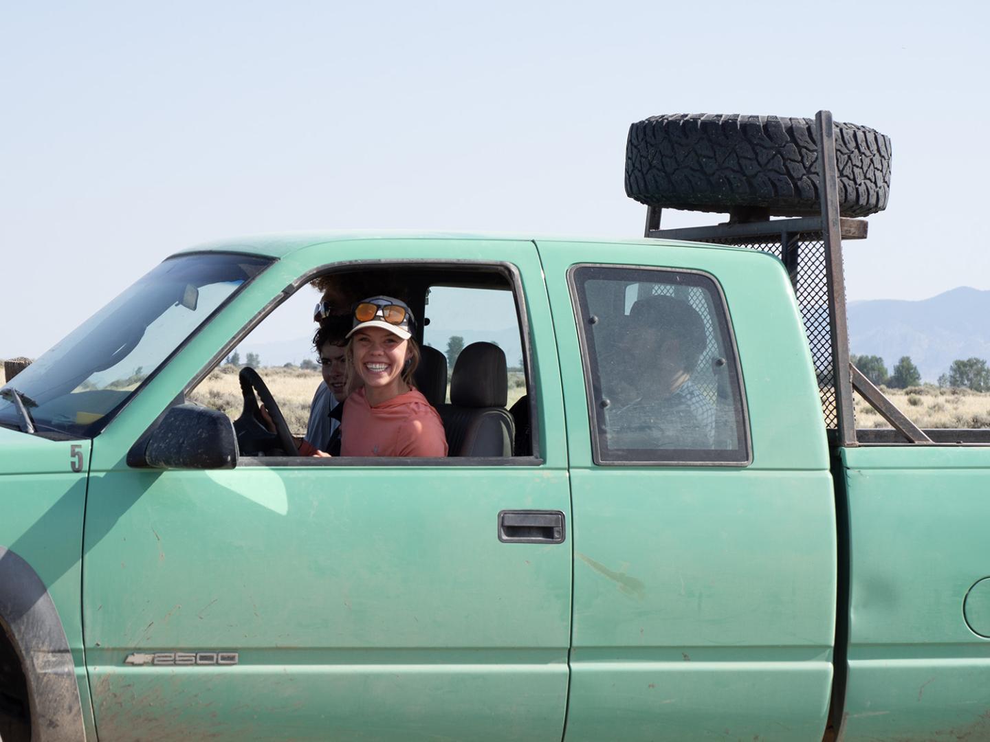 Woman drives a pickup.