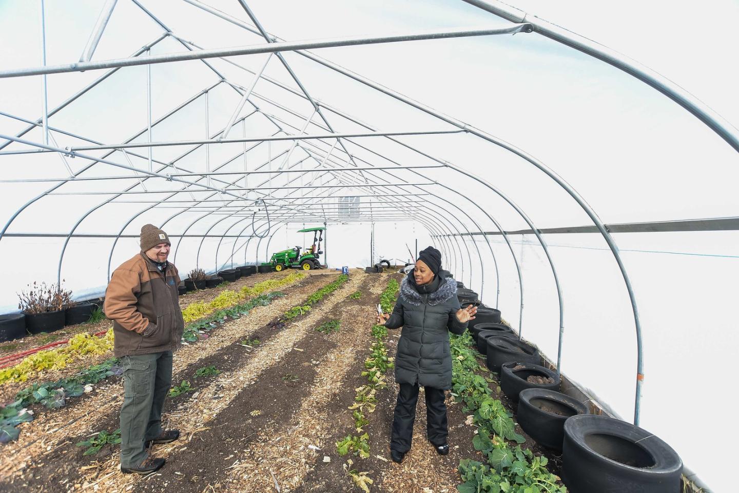 man and woman in greenhouse