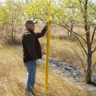 Allen Casey and Mark Jenzen measure tree height and width in arid western Kansas