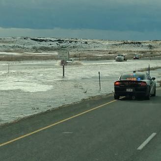 flooded highway with police car 