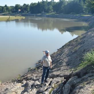 NRCS engineer examines site impacted by flooding