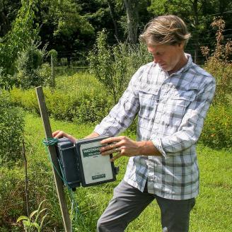 Eric Starosielski of Old Village Farm checks on his drip irrigation system.