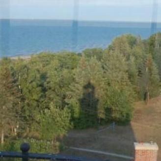 Shadow of lighthouse and shore of Lake Superior.
