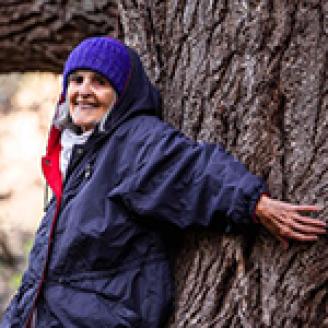 Carolyn Seachris leans against her favorite tree.