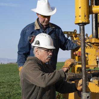 NRCS Engineers operating a drill for soil samples