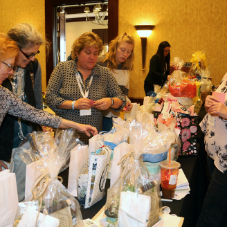2020 Rhode Island Women in Agriculture conference attendees peruse the basket raffle prizes.