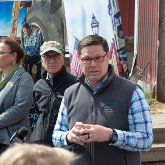 Travis Thomason speaks to press at the Earth Day event