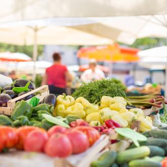 Colorful fruits and vegetables displayed at a farmers market booth