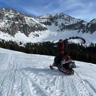 snow and mountains with sledder