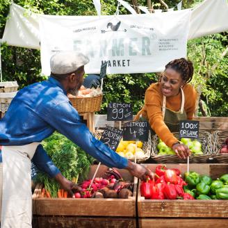 people at farmers market stand