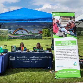 An informational booth at an outdoor festival.