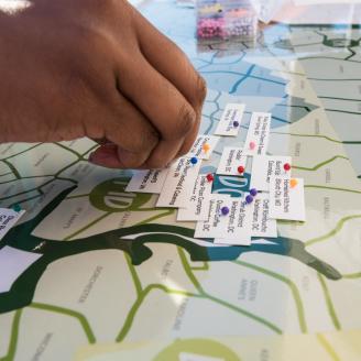 U.S. Department of Agriculture (USDA) Agricultural Marketing Service (AMS) Kayla Johnson sets the location pins that show where today's vendors have come from for the USDA Farmers Market that celebrates its close of the 22nd season on Oct 27, 2017, in Washington, DC. The last market day featured live music from the U.S. Army Band, farm animal exhibits. Visitors were able to bowl with squash, help harvest and learn about sweet potatoes for DC Central Kitchen, pick and paint pumpkins, meet farm animals, shop
