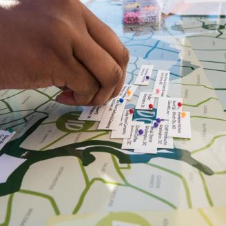 U.S. Department of Agriculture (USDA) Agricultural Marketing Service (AMS) Kayla Johnson sets the location pins that show where today's vendors have come from for the USDA Farmers Market that celebrates its close of the 22nd season on Oct 27, 2017, in Washington, DC. The last market day featured live music from the U.S. Army Band, farm animal exhibits. Visitors were able to bowl with squash, help harvest and learn about sweet potatoes for DC Central Kitchen, pick and paint pumpkins, meet farm animals, shop 