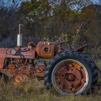 William Harrison is a multi-generational Native American rancher who raises 100 head of cattle on his farm in of Okfuskee County, Oklahoma.
Here, his family Farmall Tractor sits unused in the pasture.
USDA photo by Preston Keres.
