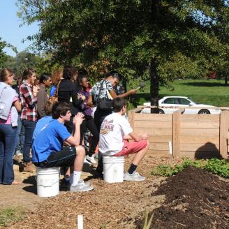 Students listen to Environmental Science teacher, Patrick Earl, as he talks about the section of the community garden that T. C. Williams High School is responsible for maintaining.  This is T. C. Williams Project Discovery for green gardening.  USDA and its partners visited the school on Wednesday, Oct. 7, 2009.