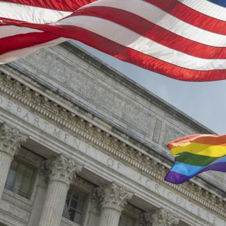 Agriculture Secretary Tom Vilsack and Deputy Secretary of Agriculture Dr. Jewel H. Bronaugh review the Progress Pride Flag flying at the United States Department of Agriculture in Washington, D.C. on June 8, 2021. USDA photo by Tom Witham.
