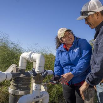 Sang Lee Farms co-owner William Lee and Liz Camps, District Conservationist look over a recenlty-installed Acclima Soil Moisture Sensor for Irrigation Water Management on the farm in Peconic, New York, November 5, 2021. 
Sang Lees Farms, transitioning to third generation, grows more than 100 varieties of specialty vegetables, heirloom tomatoes, baby greens, herbs. They continue to feature Asian produce, growing many varieties of Chinese cabbages, greens, and radishes. 
The farm has been operating and growin