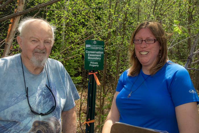 Landowner Robert ‘Bob’ Kidder (left) and USDA, NRCS District Conservationist for Coӧs County, Kelly Eggleston (right) pose for a photo at his property in Stark, N.H. May 13, 2022.  Kidder recently closed on putting his land into a conservation easement that will protect it in perpetuity. (USDA photo by Jeremy J. Fowler, NRCS, N.H.)