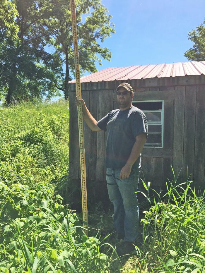 Henry Holets helps survey his water system.