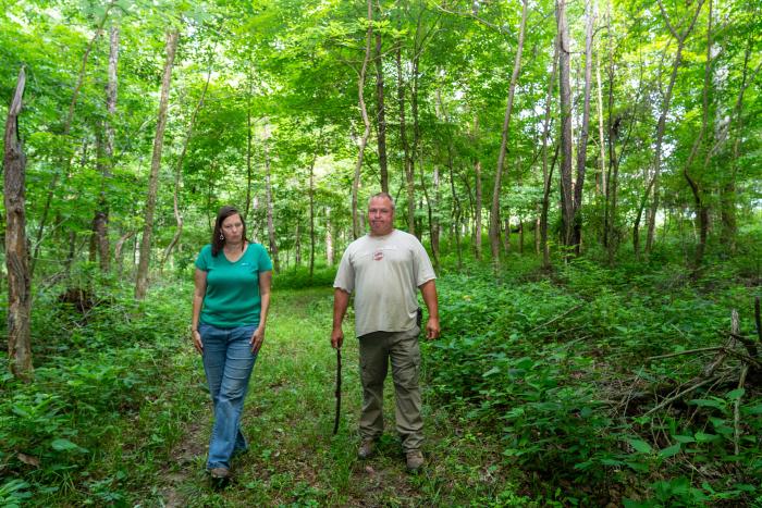 Louie Lane and Indiana NRCS District Conservationist for Franklin County walk through Lane's forest land in Oldenburg, IN.