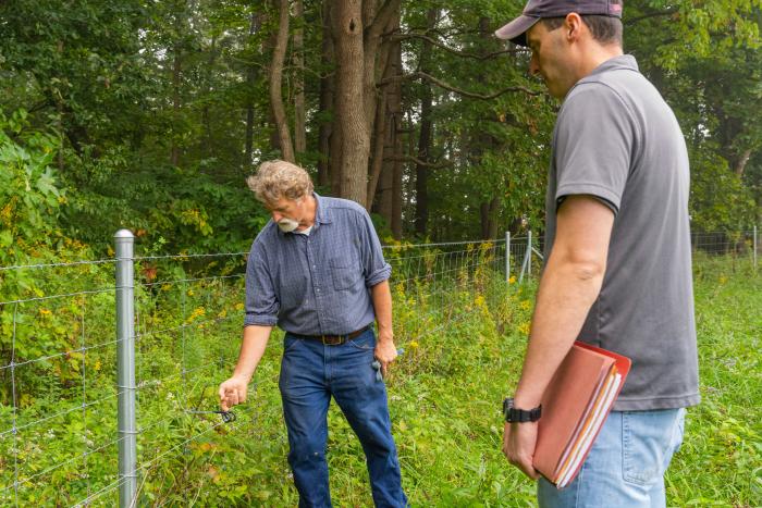 Indiana NRCS district conservationist Thomas Perkins (left) and Jerry Bates inspect a fence at Bates' beef cattle operation in Cloverdale, IN