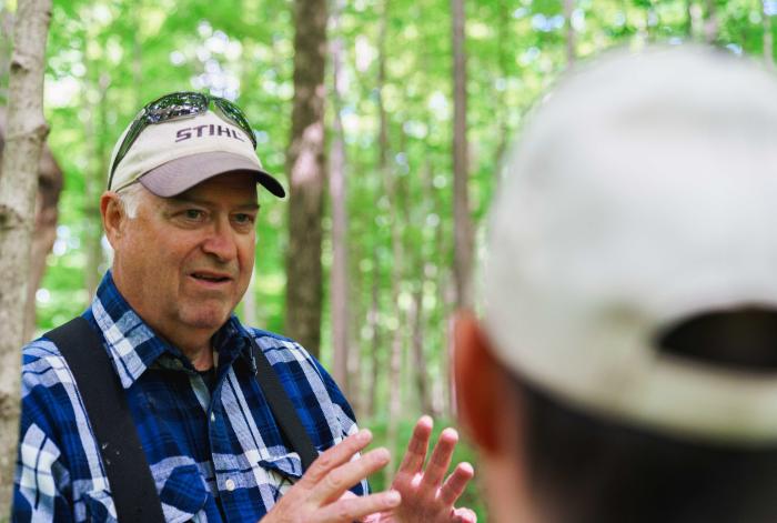 Sam St. Clair (left) gives a tour of his forestland in Whitley County, Indiana to NRCS district conservationist Jeremy Palmer June 9, 2022.