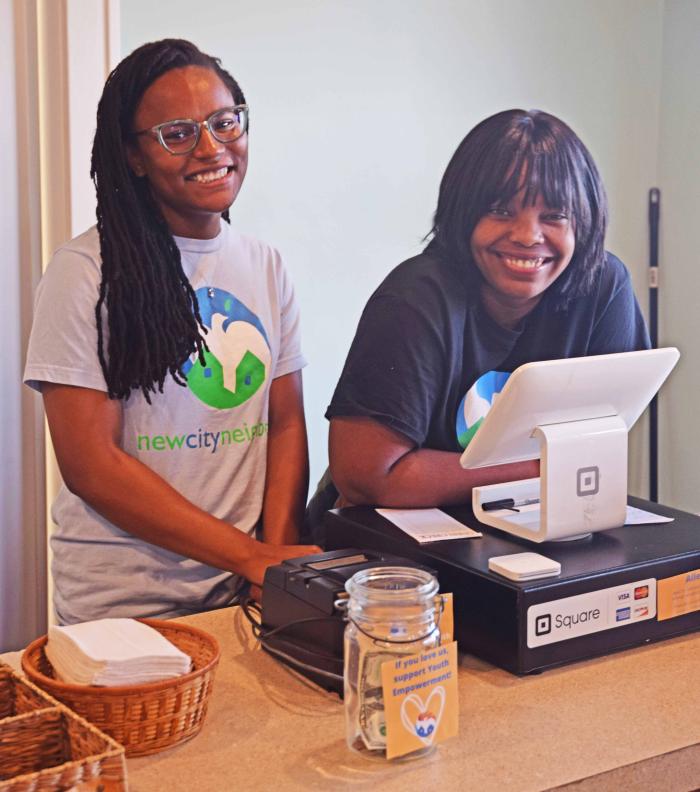 Sierra West-Smith (on left), New City Neighbors Neighborhood Engagement Coordinator, helps supervise employees at the cafe.