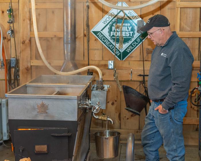 Joe Velovitch boils maple sap into syrup at Springboro Tree Farms in Brookston, Indiana Feb. 13, 2023.