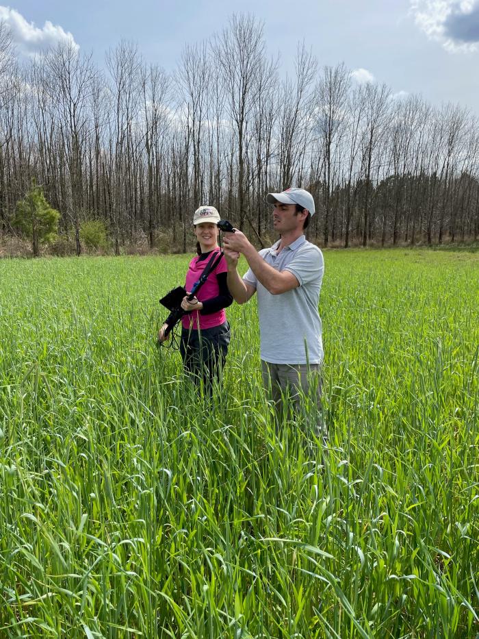 Dr. Fernando Oreja and April Dobbs prepare the GoPro camera for taking videos of the cereal rye cover crop