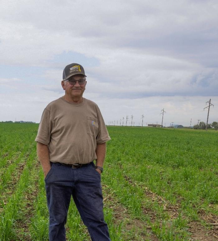 A producer standing in his soybean field.